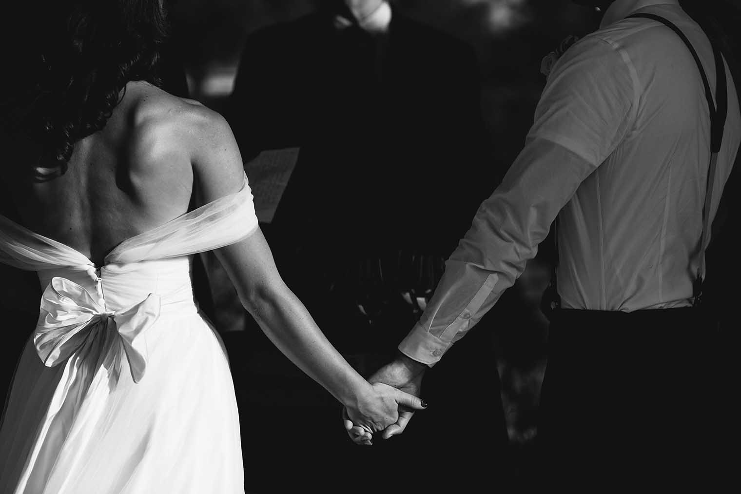 bride and groom holding hands at farmstead at long meadow ranch wedding