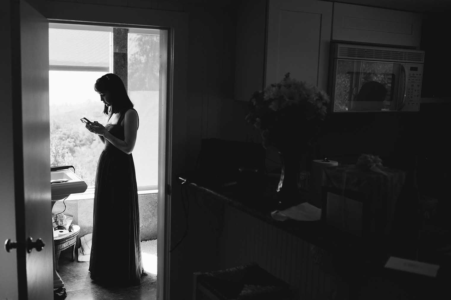 Bridesmaid texting during the getting ready