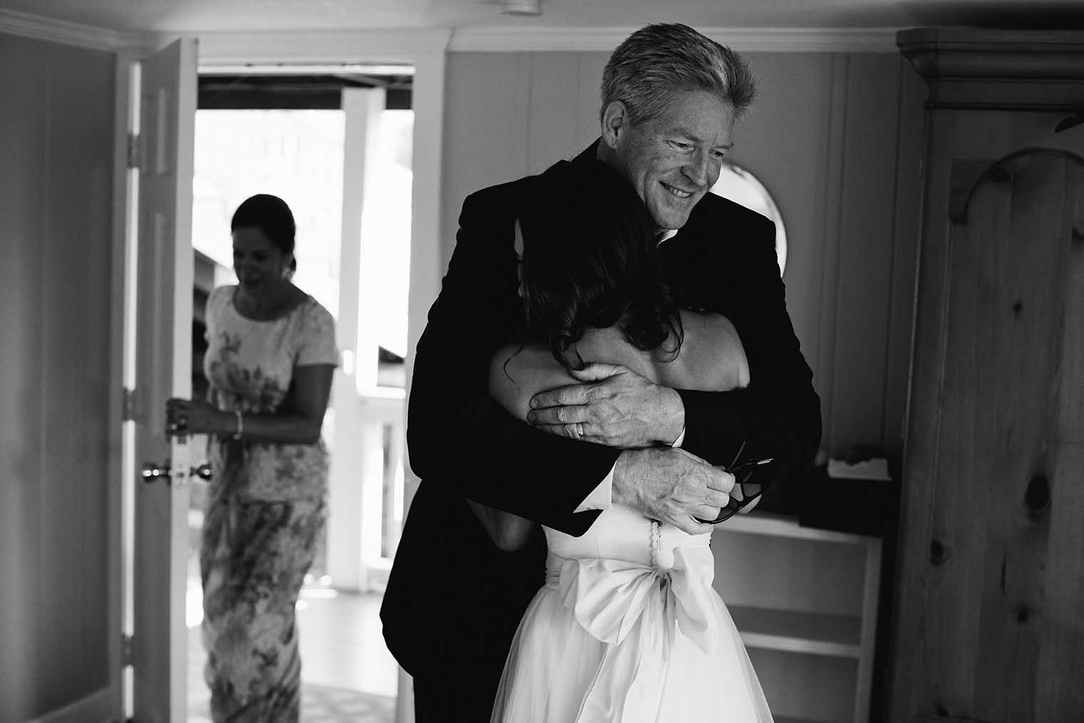 Bride and father hugging 